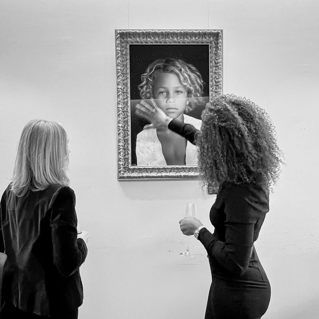 artist marie de decker showing her art to a client